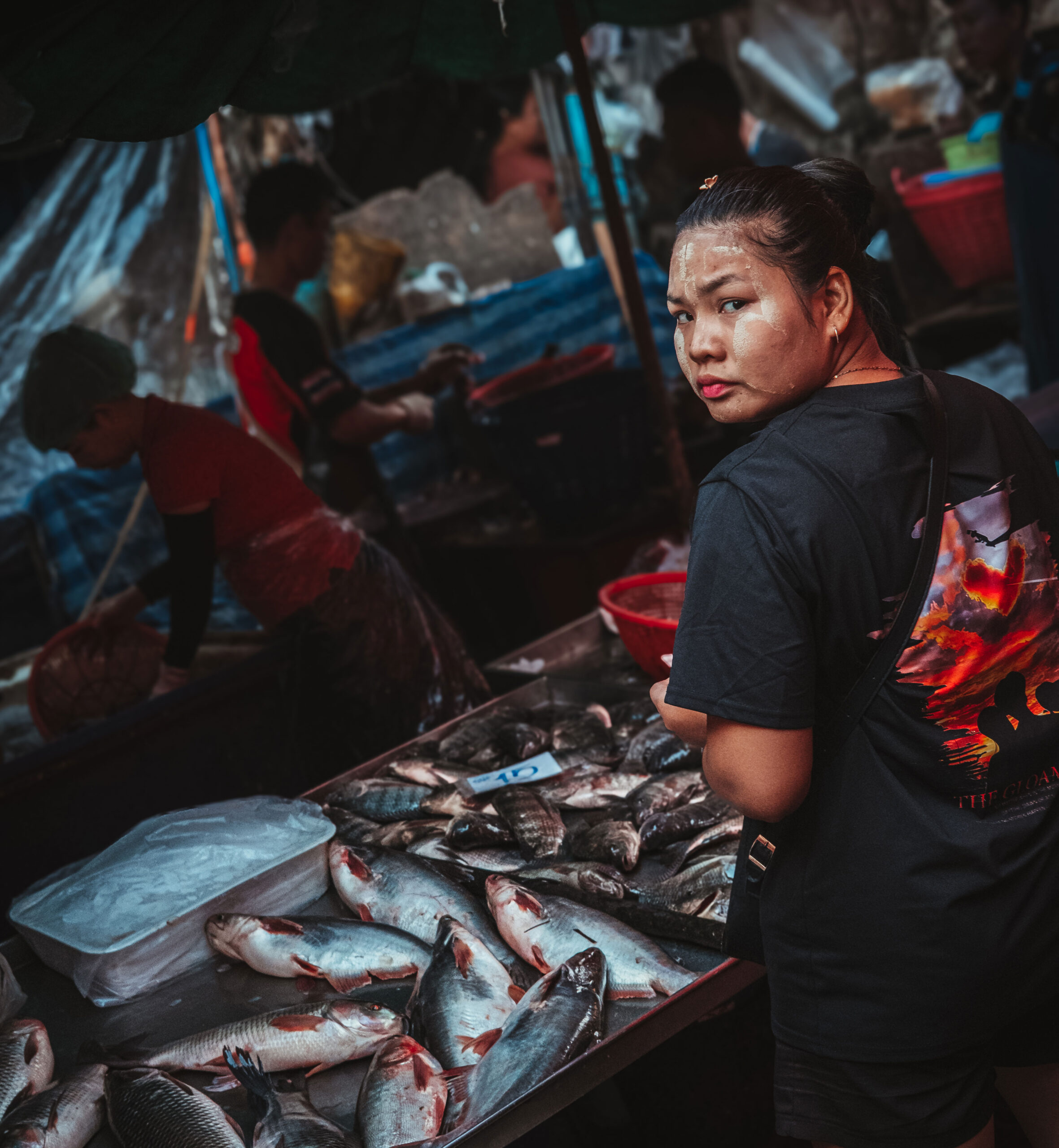 Photography of a lady selling fish, from documentary in Khlong Toei wet market in Bangkok, Thailand, 2026